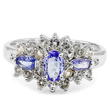 A oval cut tanzanite with a marquise cut tanazanite on either side and a mix of white topaz and diamonds on a sterling silver band ring 