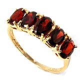 A stunningly beautiful 2.33 carat (tw) 5 oval cut genuine Garnets on a 10KT solid yellow gold ring. 