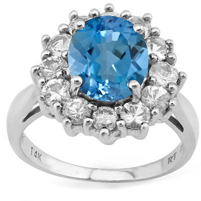 A stunning oval cut swiss blue topaz gemstone surrounded by white sapphires on a 14KT Solid White Gold Ring